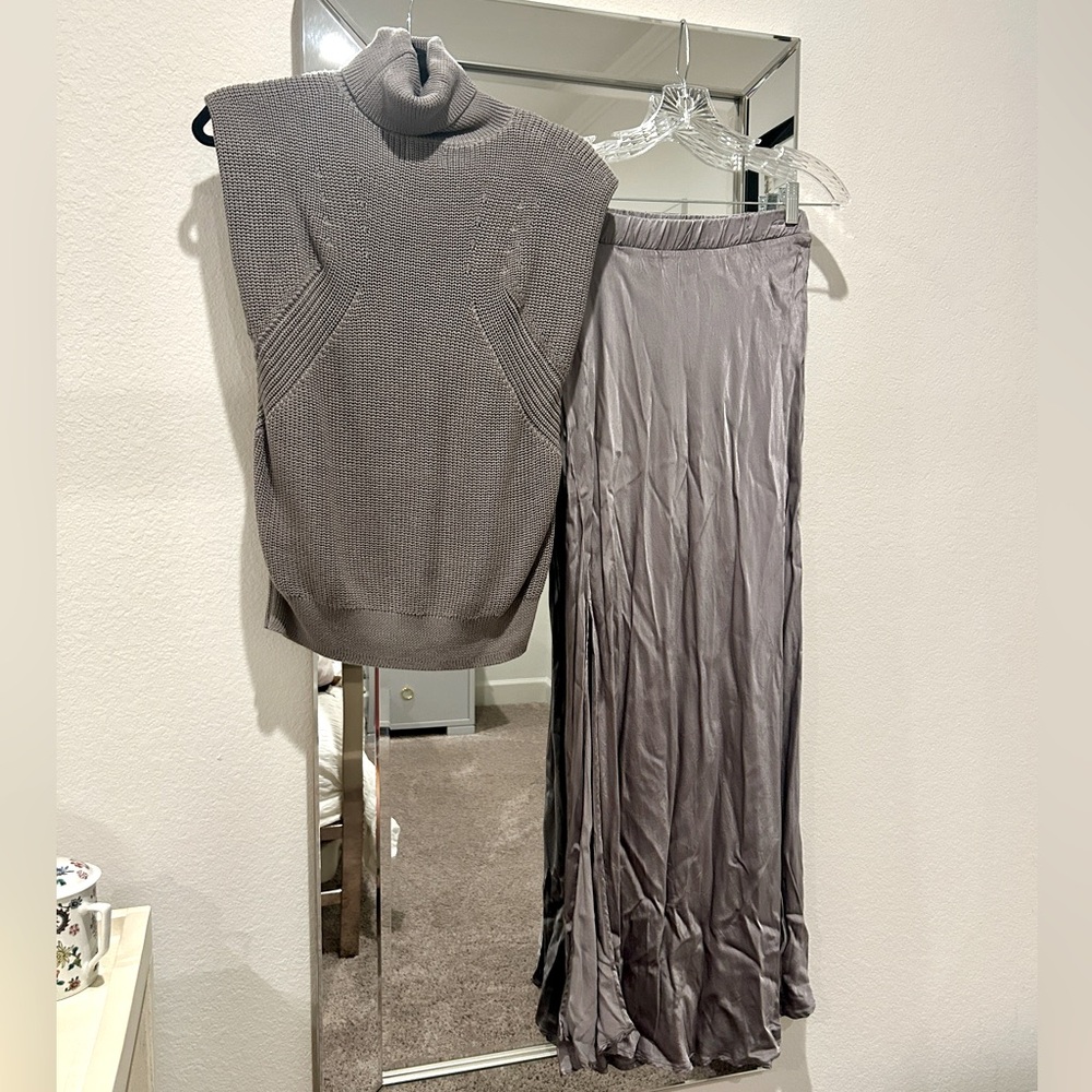 Long silky skirt with a slit with matching sleeveless sweater.